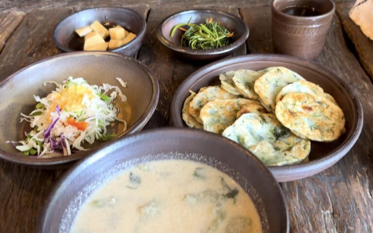 Perilla seed soup with buckwheat dumplings (deulkkae sujebi) and buchim potato Korean pancakes - Dasoni Jeju Island