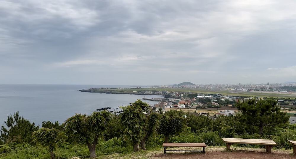 View from DoDuBong peak in Jeju of sea and green trees and houses
